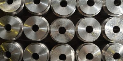 The texture of the round parts with a hole in the center at the plant for the production of valves. Close up